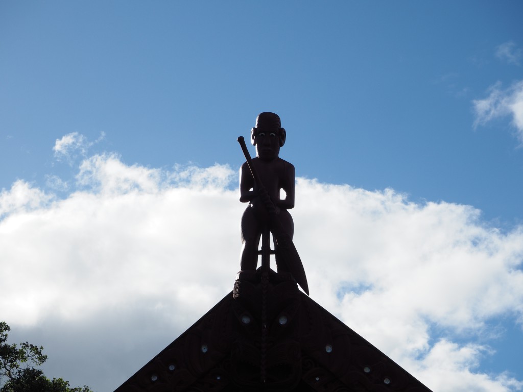 A Maori carved figure overlooks us on top of the treaty house at Waitangi